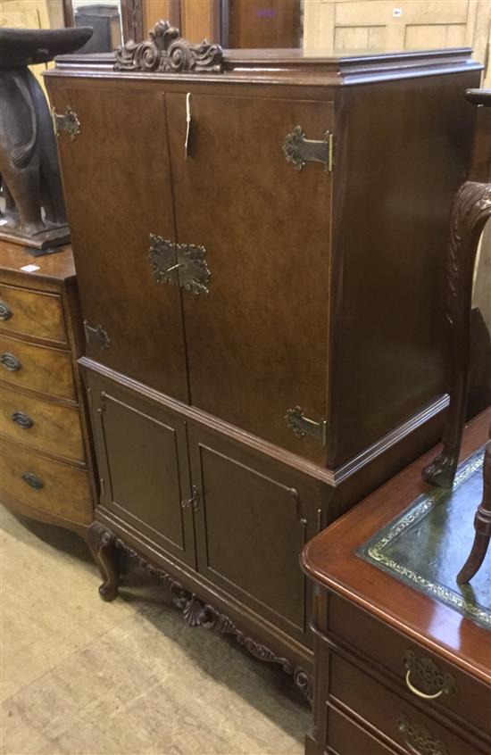 An 18th century style walnut cocktail cabinet,